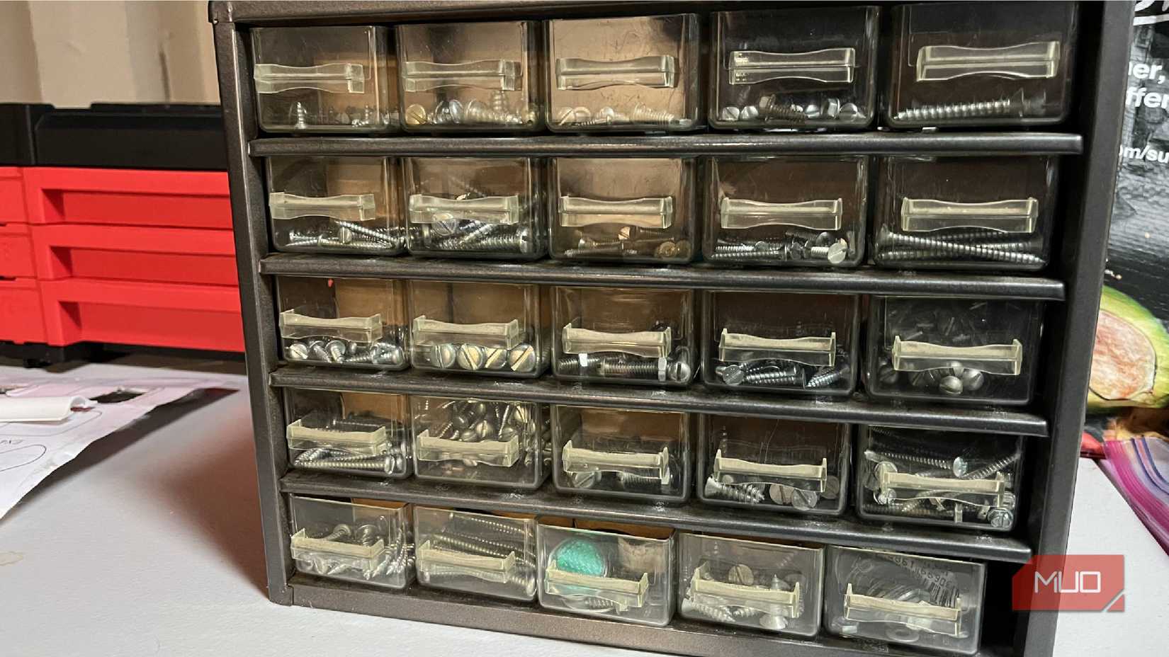 A small bin organizer with nuts screws and nails in it