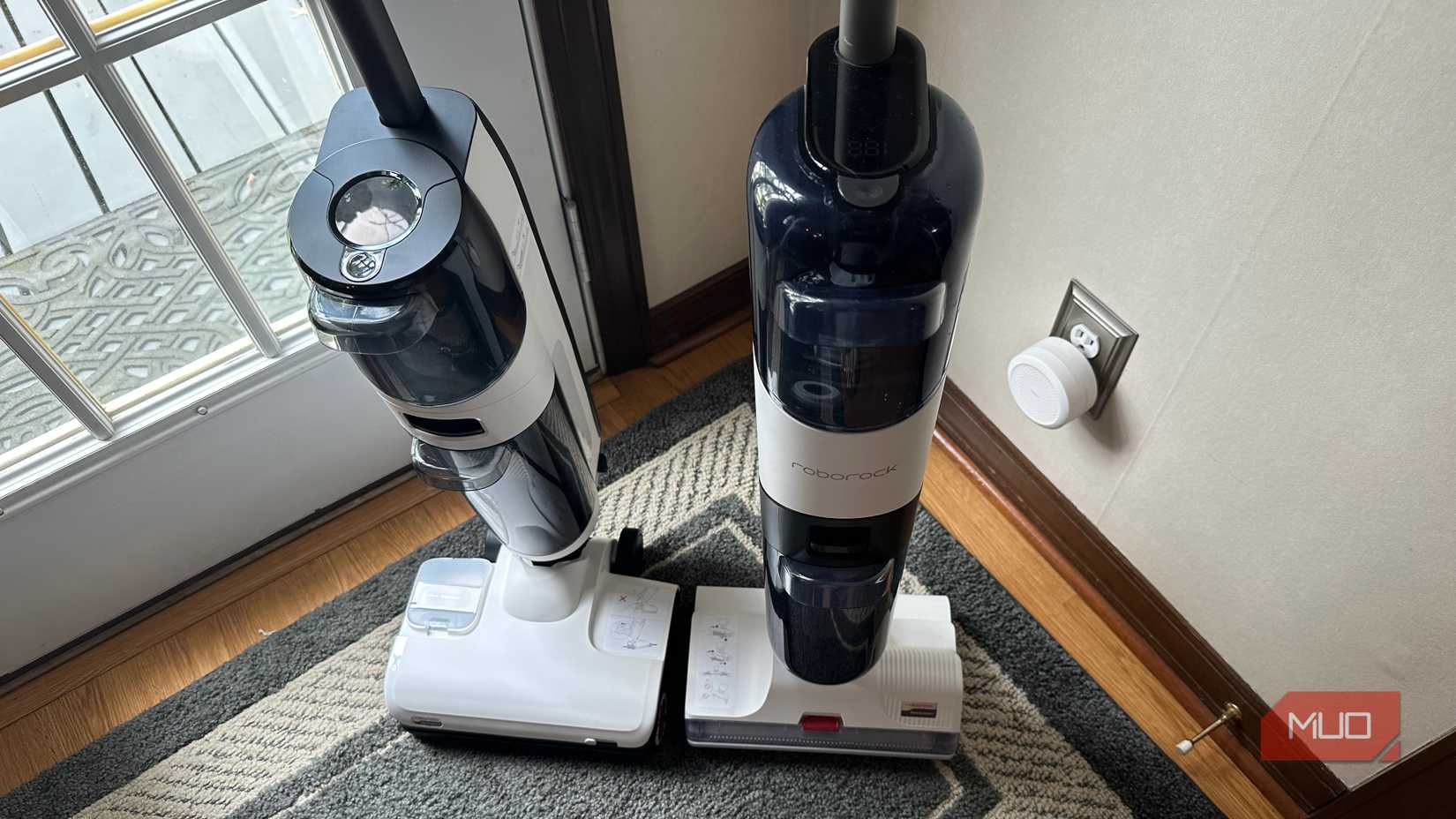 Two upright all-in-one vacuums in a home.