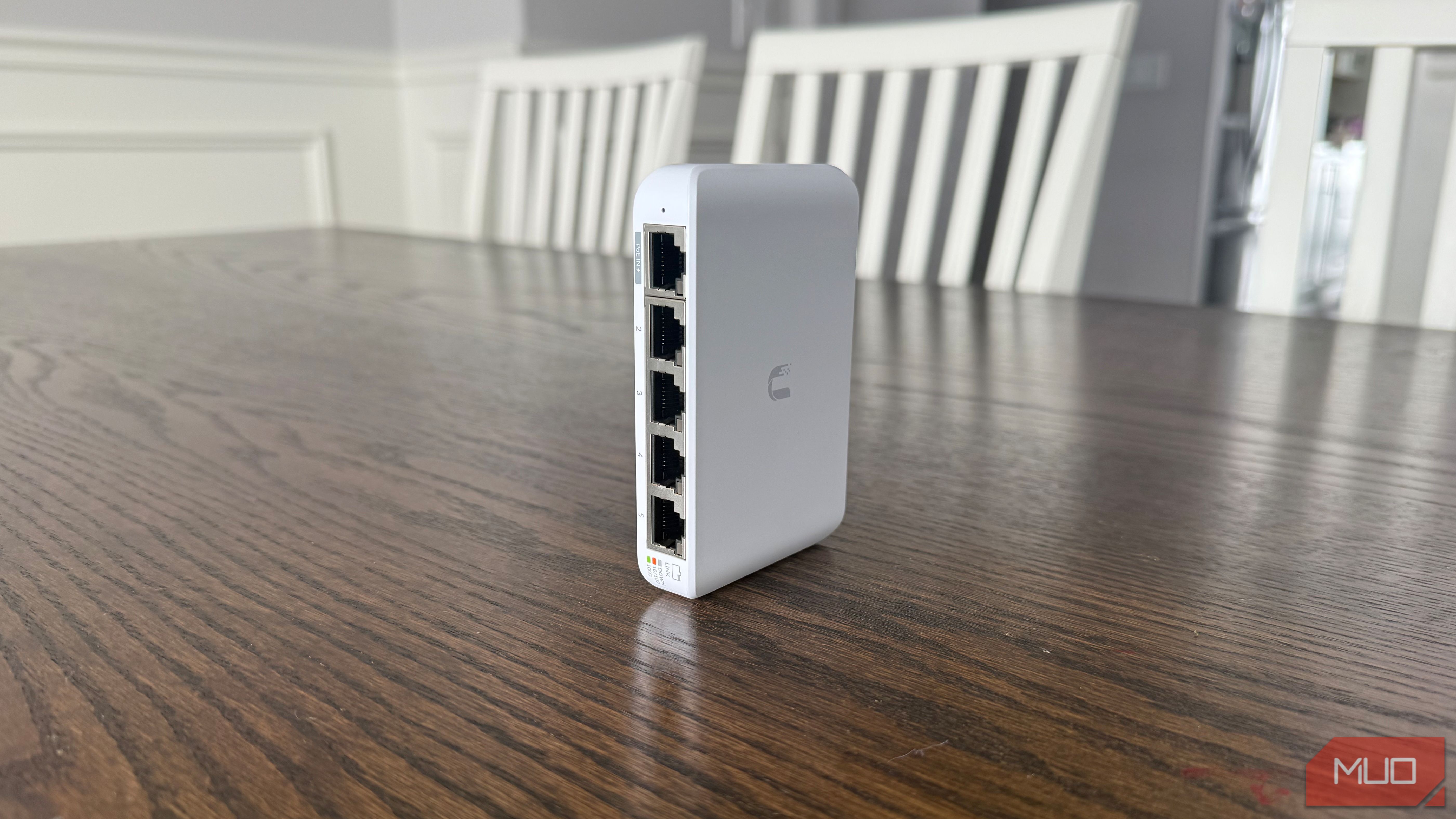 Ubiquiti compact network switch on brown table