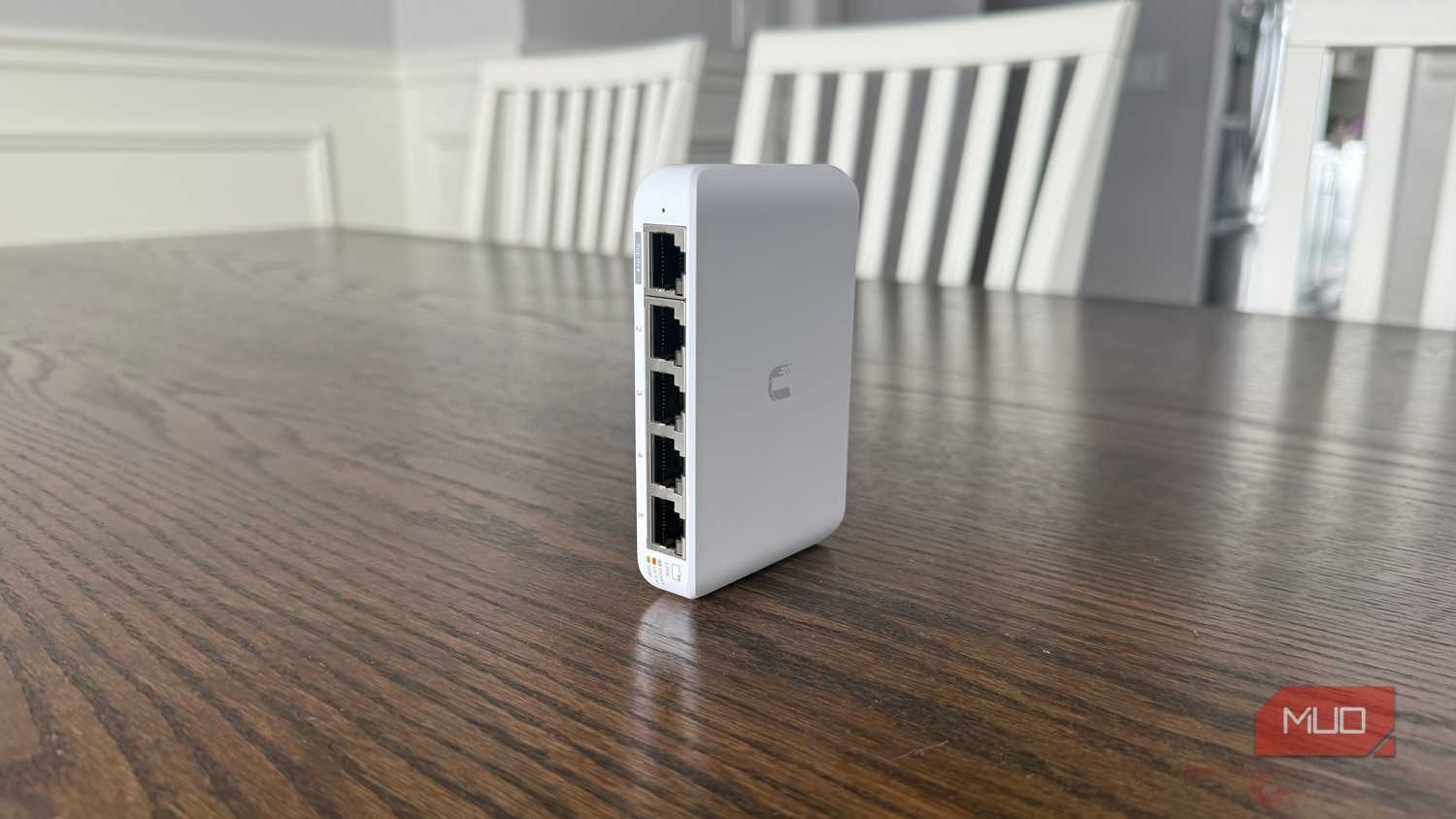 Ubiquiti compact network switch on brown table