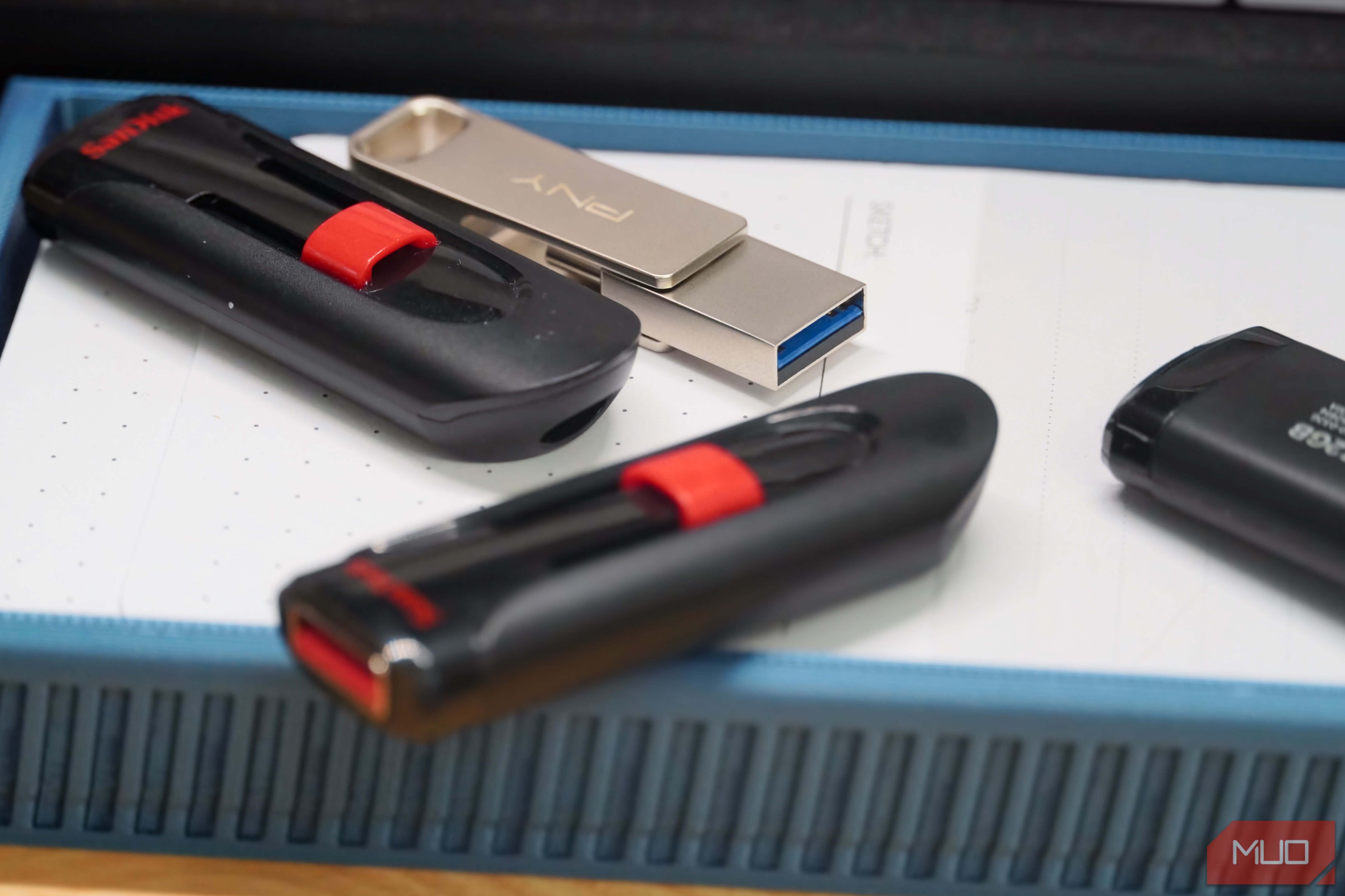 USB drives scattered on a desk.