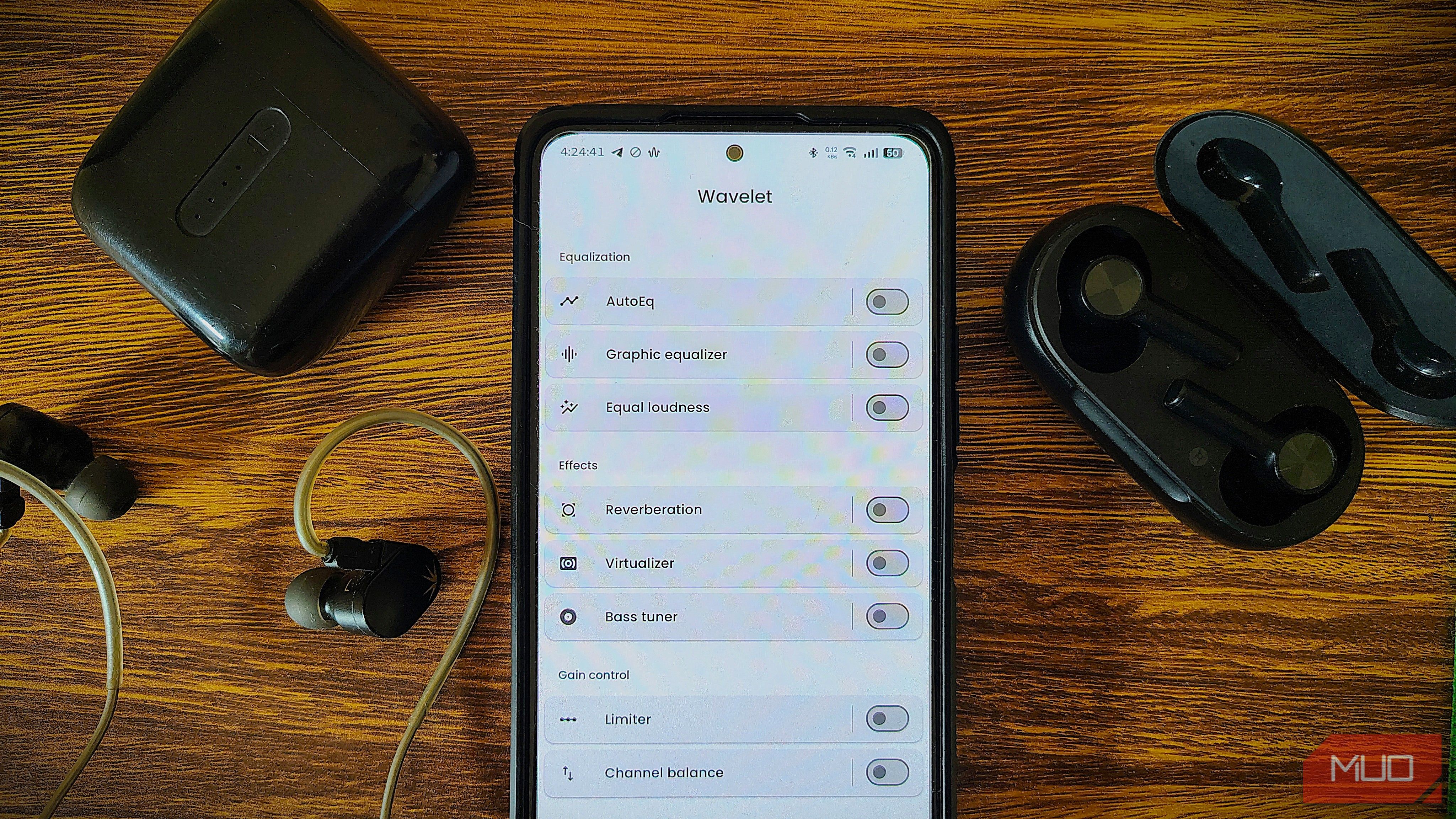 Wavelet app on Android phone surrounded with verious headphones and IEM.