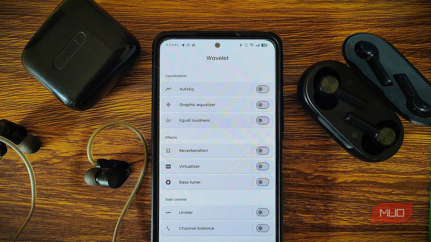 Wavelet app on Android phone surrounded with verious headphones and IEM.