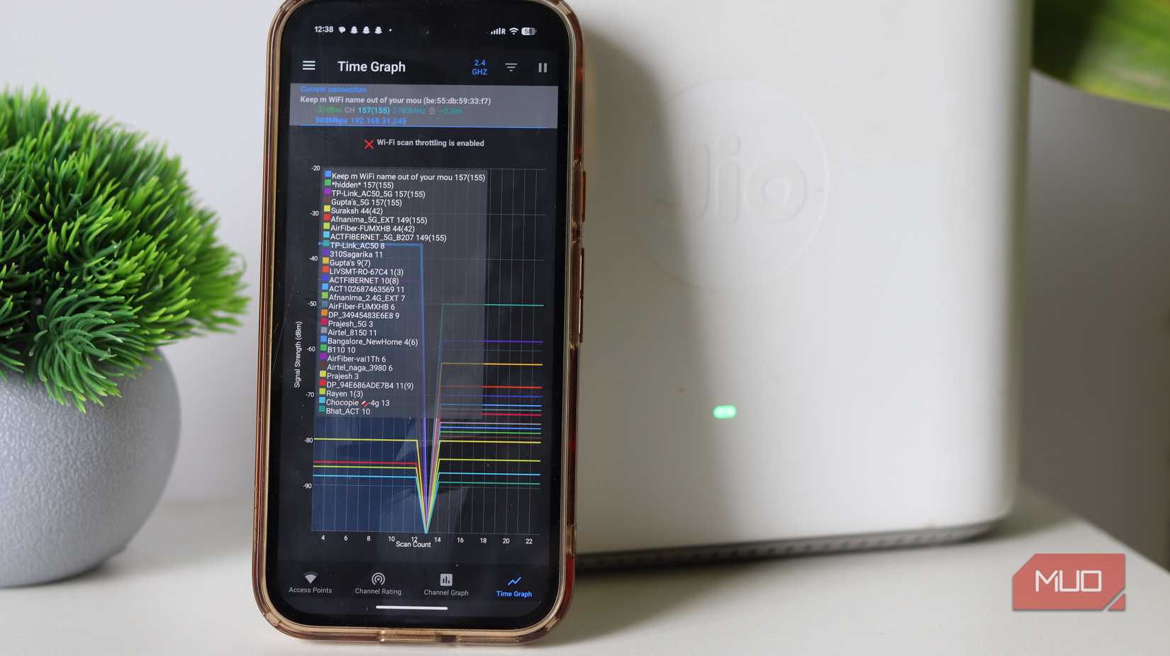 Wifi time graph on phone in front of wifi router.