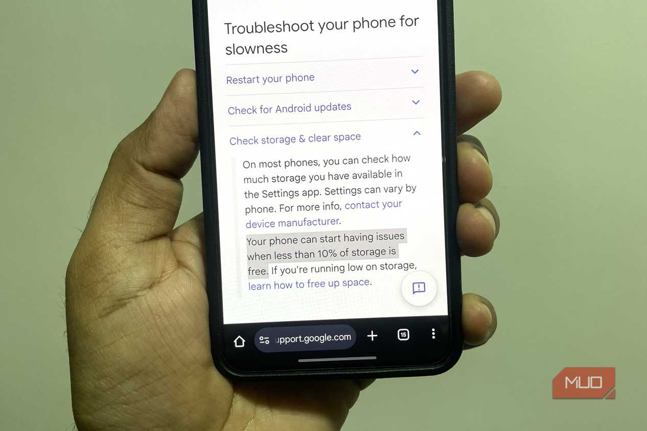 Android phone in hand showing Google support page