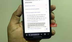 Android phone in hand showing Google support page
