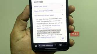 Android phone in hand showing Google support page