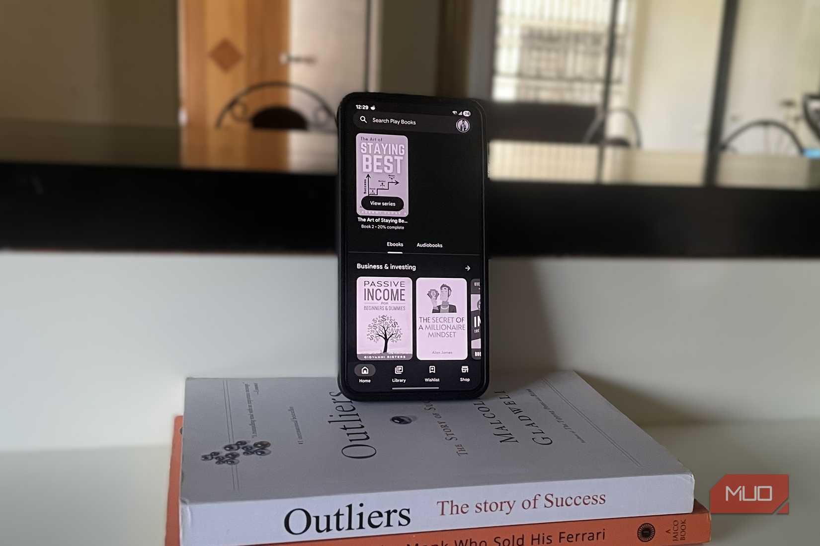 Android phone on a pile of books showing eBook
