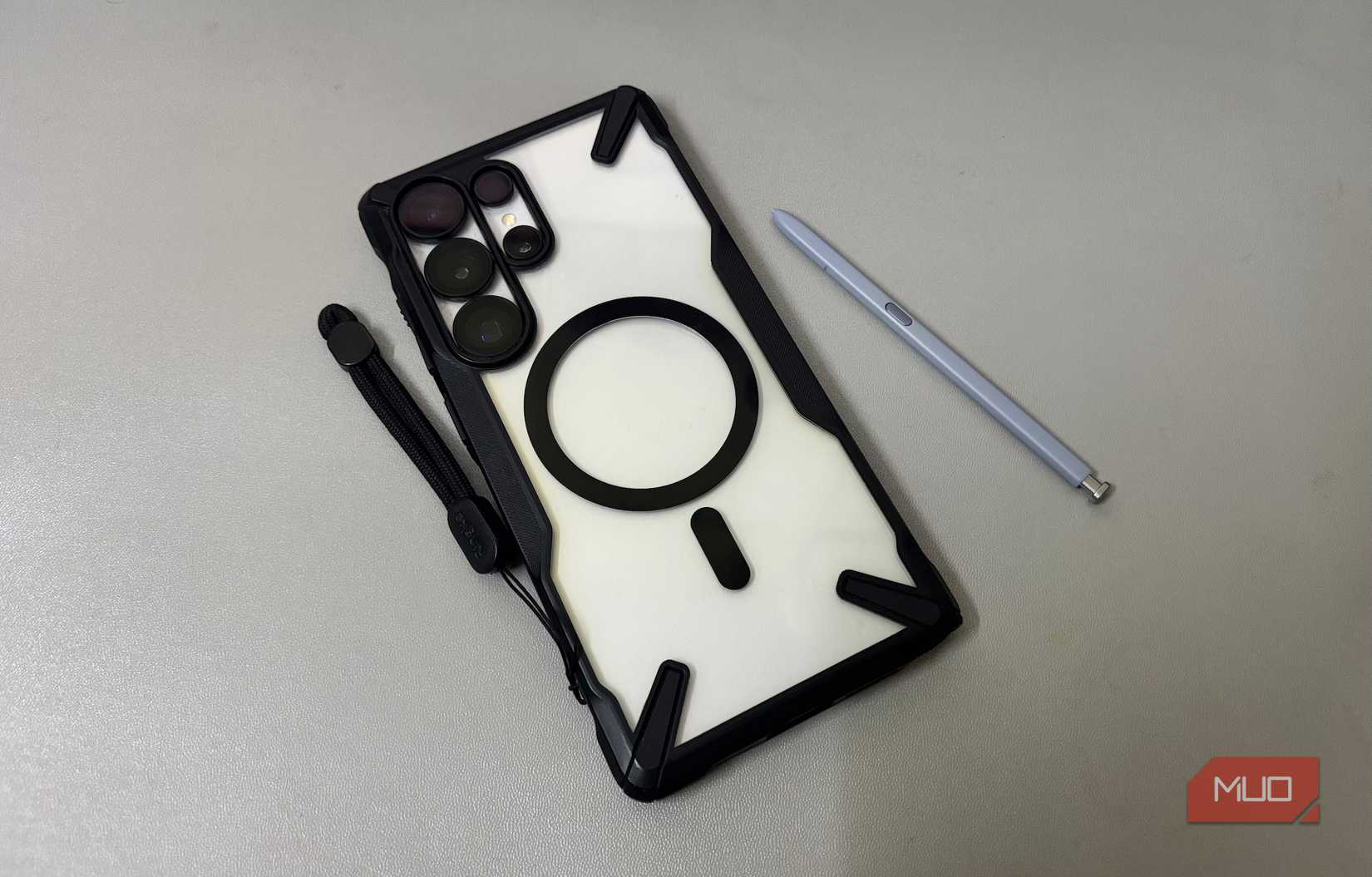 Android phone with protective case and stylus placed beside it