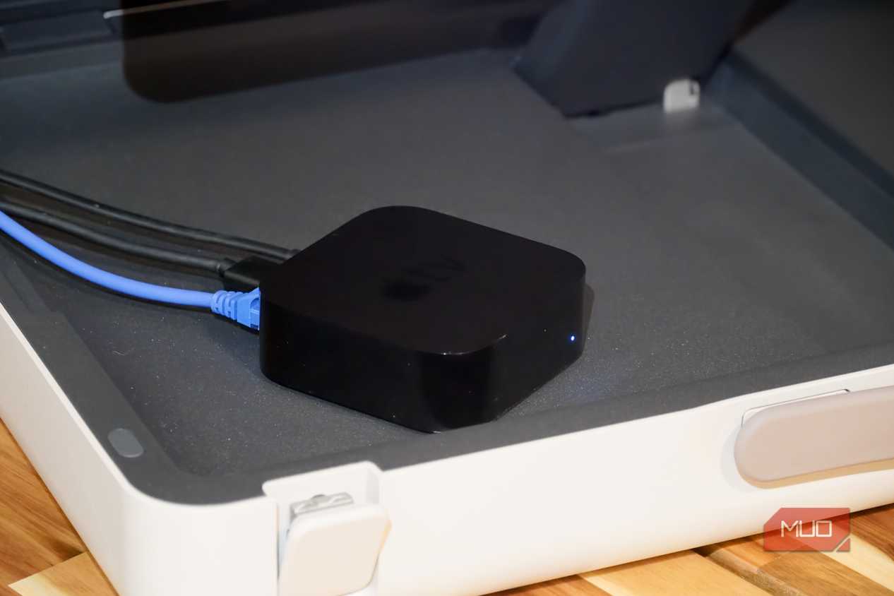 An Apple TV with a Gigabit Ethernet cable plugged in.