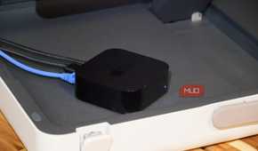 An Apple TV with a Gigabit Ethernet cable plugged in.