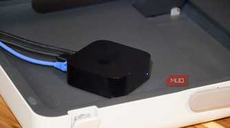An Apple TV with a Gigabit Ethernet cable plugged in.
