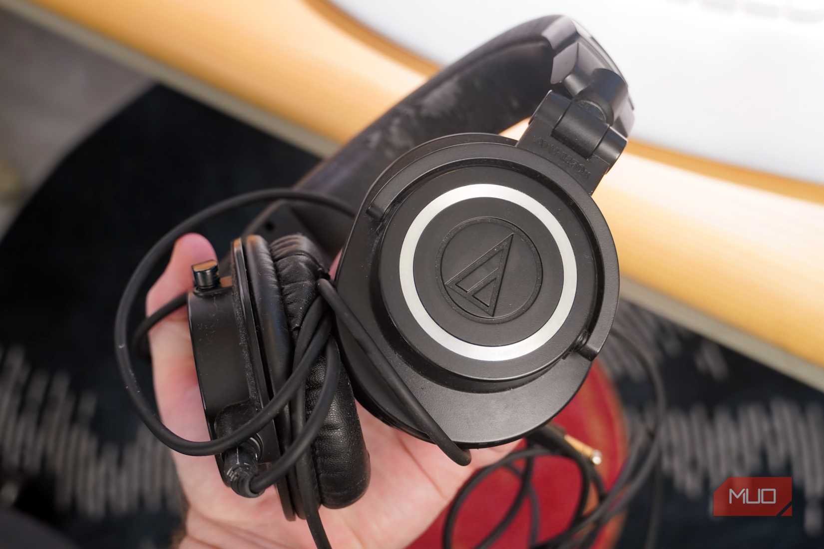 Audio Technica's ATH-M50x headphones in the hand.