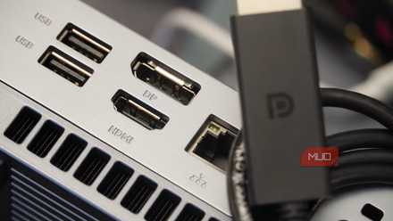 DisplayPort cable sitting atop a Mini PC with DP and HDMI inputs.