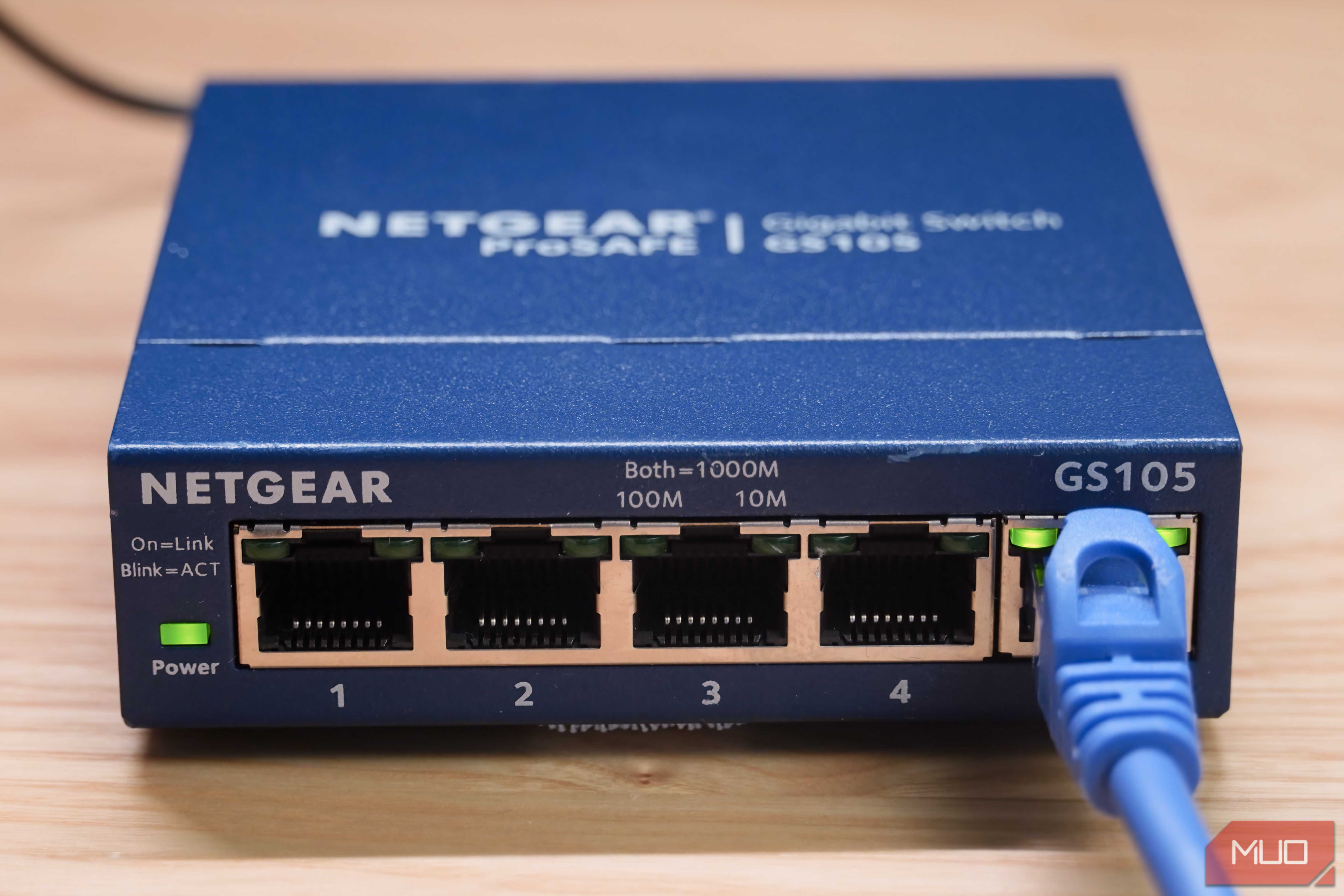 A close-up of the Ethernet cable plugged into an unmanaged switch.