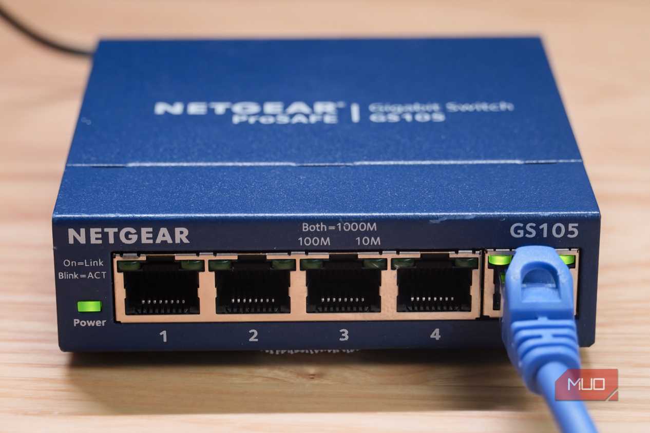 A close-up of the Ethernet cable plugged into an unmanaged switch.