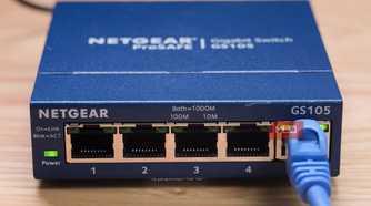 A close-up of the Ethernet cable plugged into an unmanaged switch.