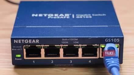 A close-up of the Ethernet cable plugged into an unmanaged switch.