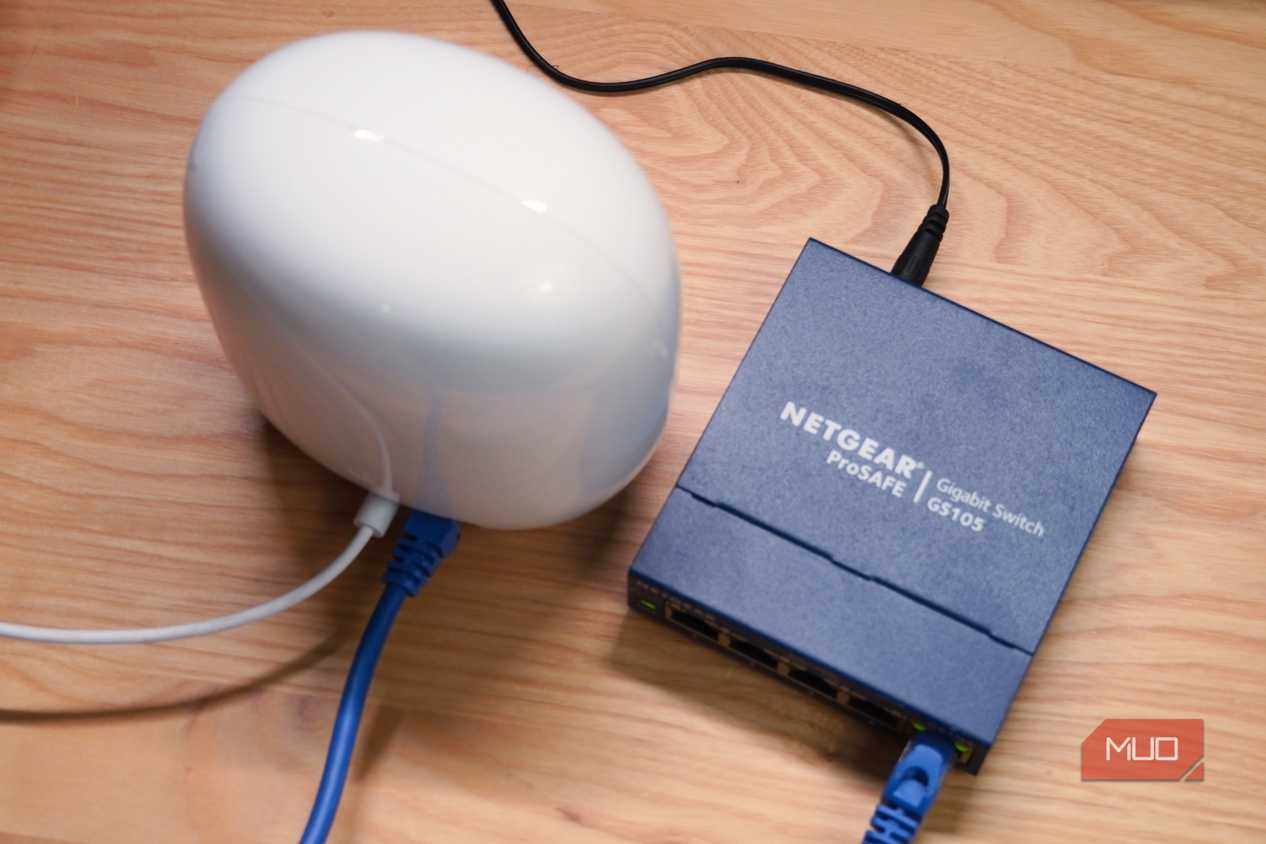 A top-down view of a Google Nest Wi-Fi Pro connected to an unmanaged networking switch.