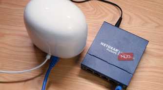 A top-down view of a Google Nest Wi-Fi Pro connected to an unmanaged networking switch.
