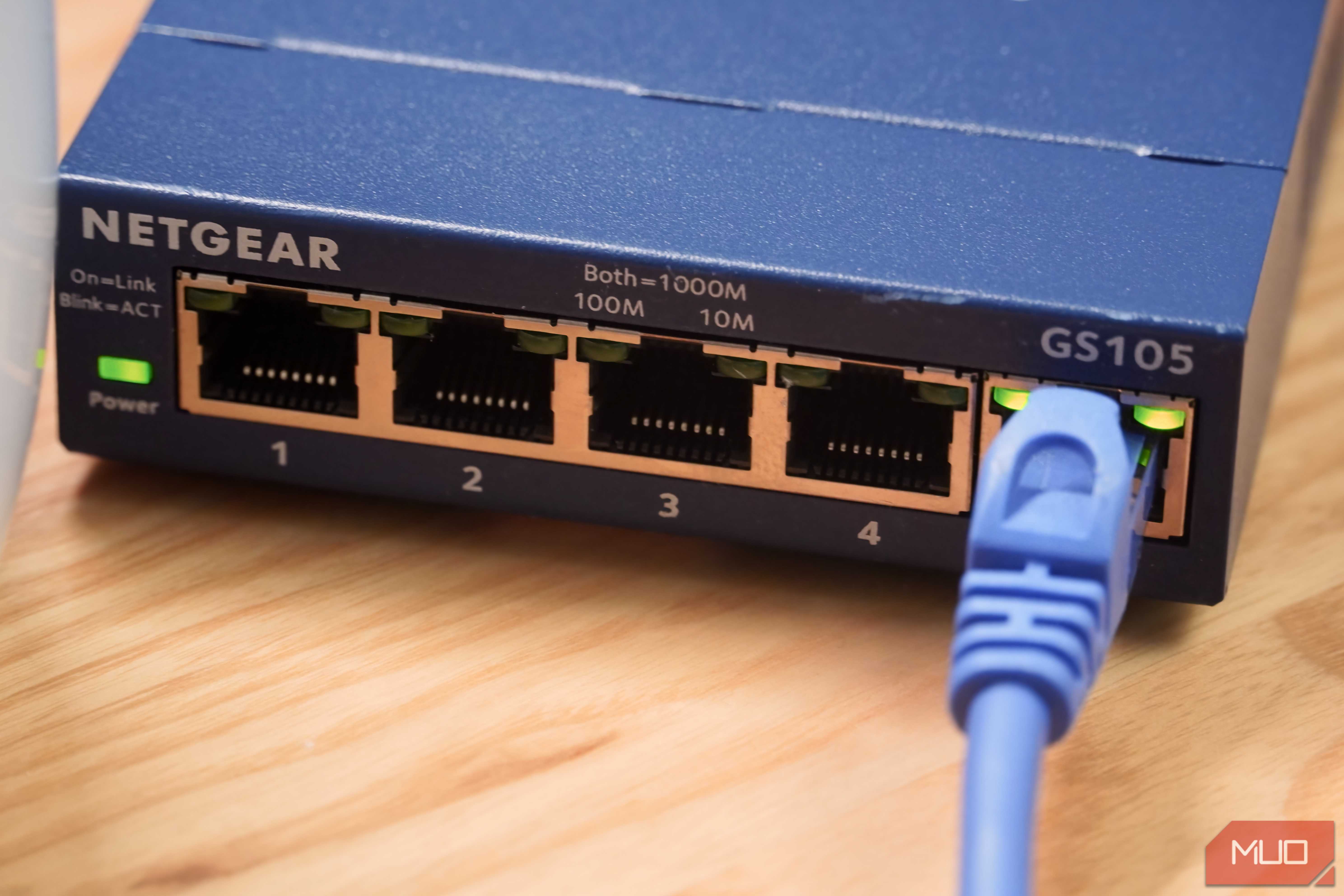 A close-up of an Ethernet cable plugged into an unmanaged switch.
