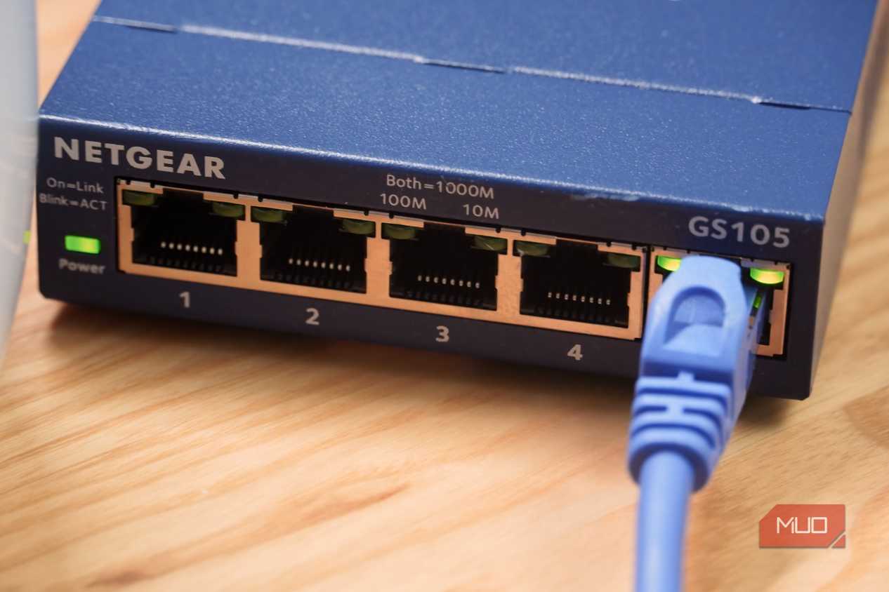 A close-up of an Ethernet cable plugged into an unmanaged switch.