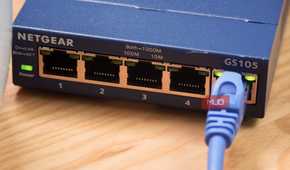 A close-up of an Ethernet cable plugged into an unmanaged switch.