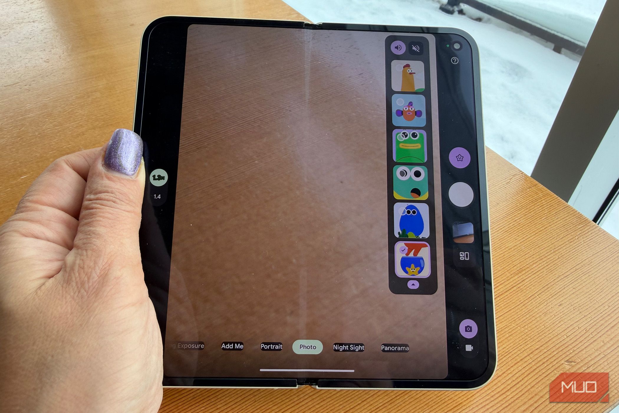 A hand holding a Google Pixel 10 Pro Fold showing different Made You Look animation options on the inner screen.