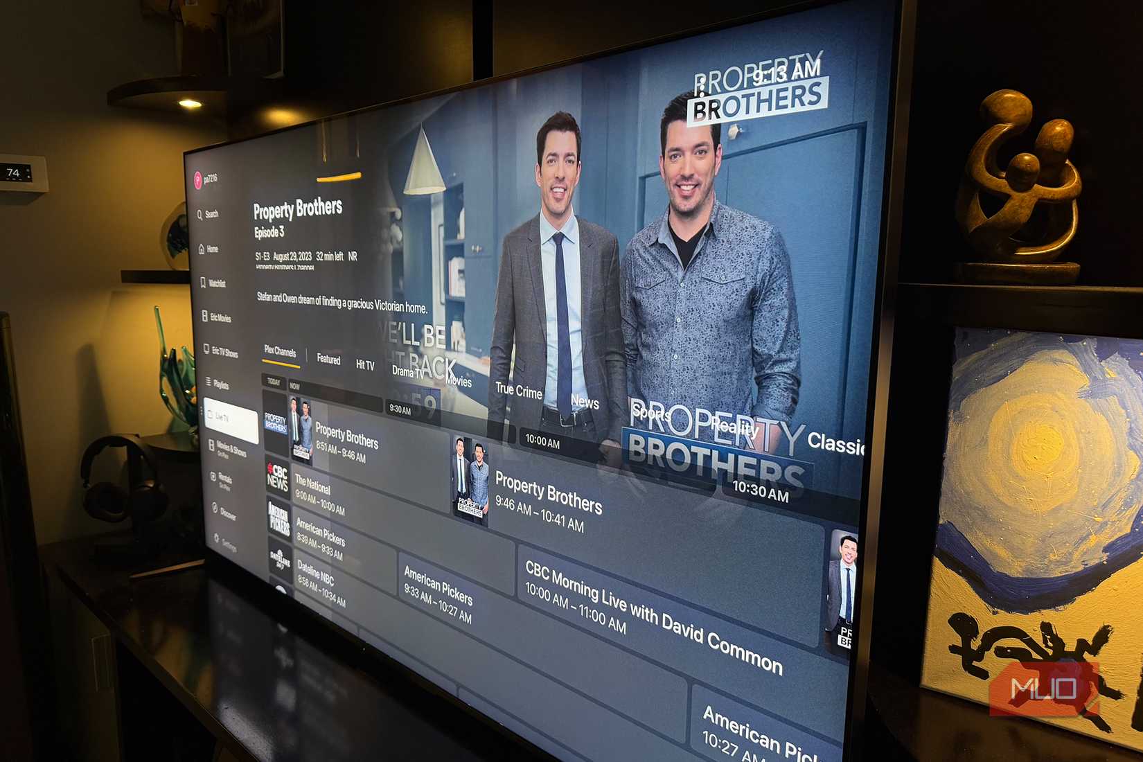 A TV showing the live TV guide for Plex.