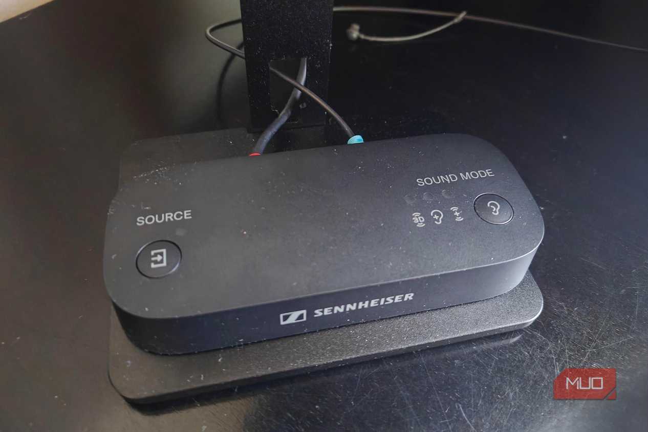 The Sennheiser BTA1 Bluetooth transmitter on a TV stand.