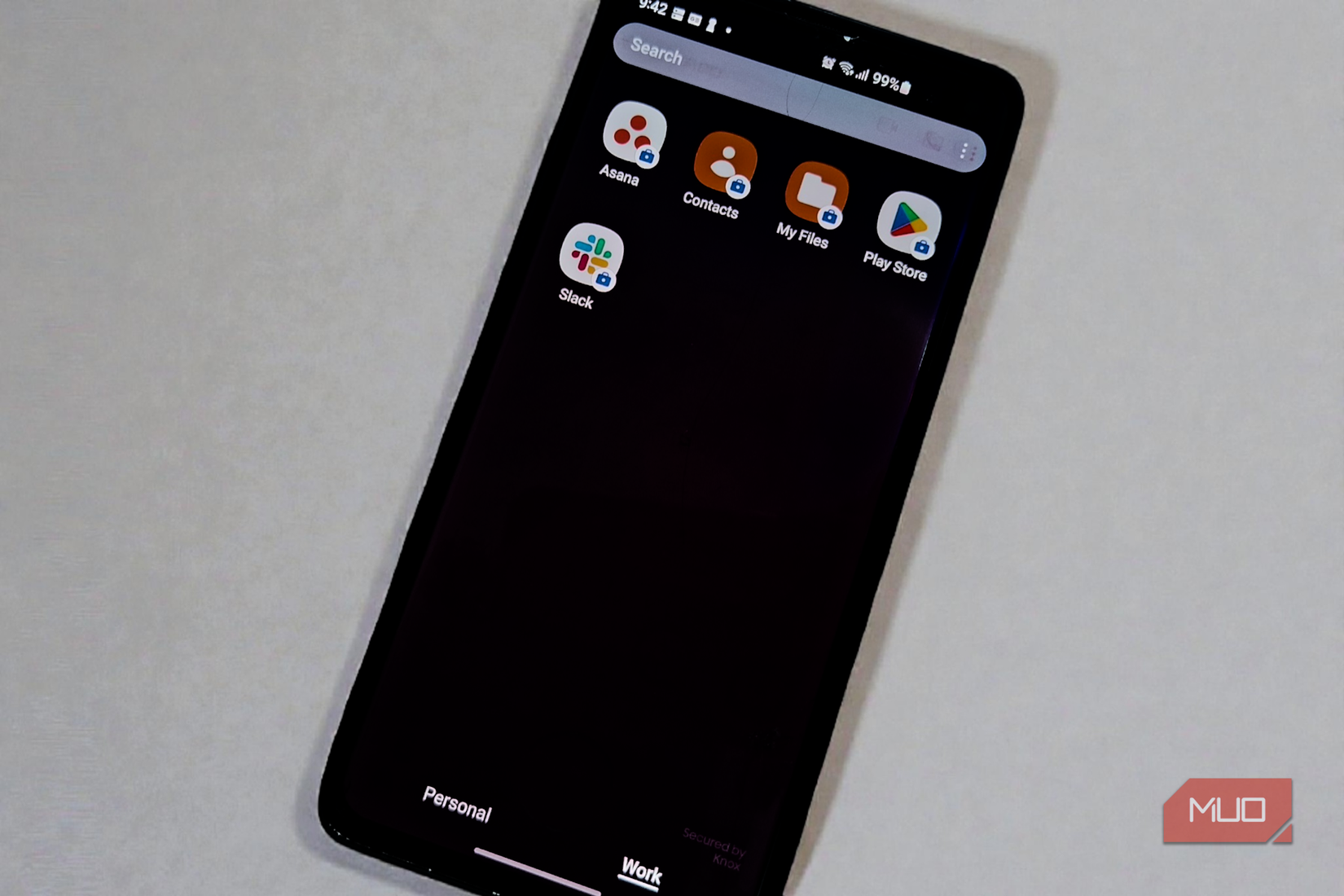 Smartphone showing isolated work profile apps, including Asana and Slack, with the Work tab selected.