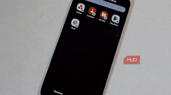 Smartphone showing isolated work profile apps, including Asana and Slack, with the Work tab selected.