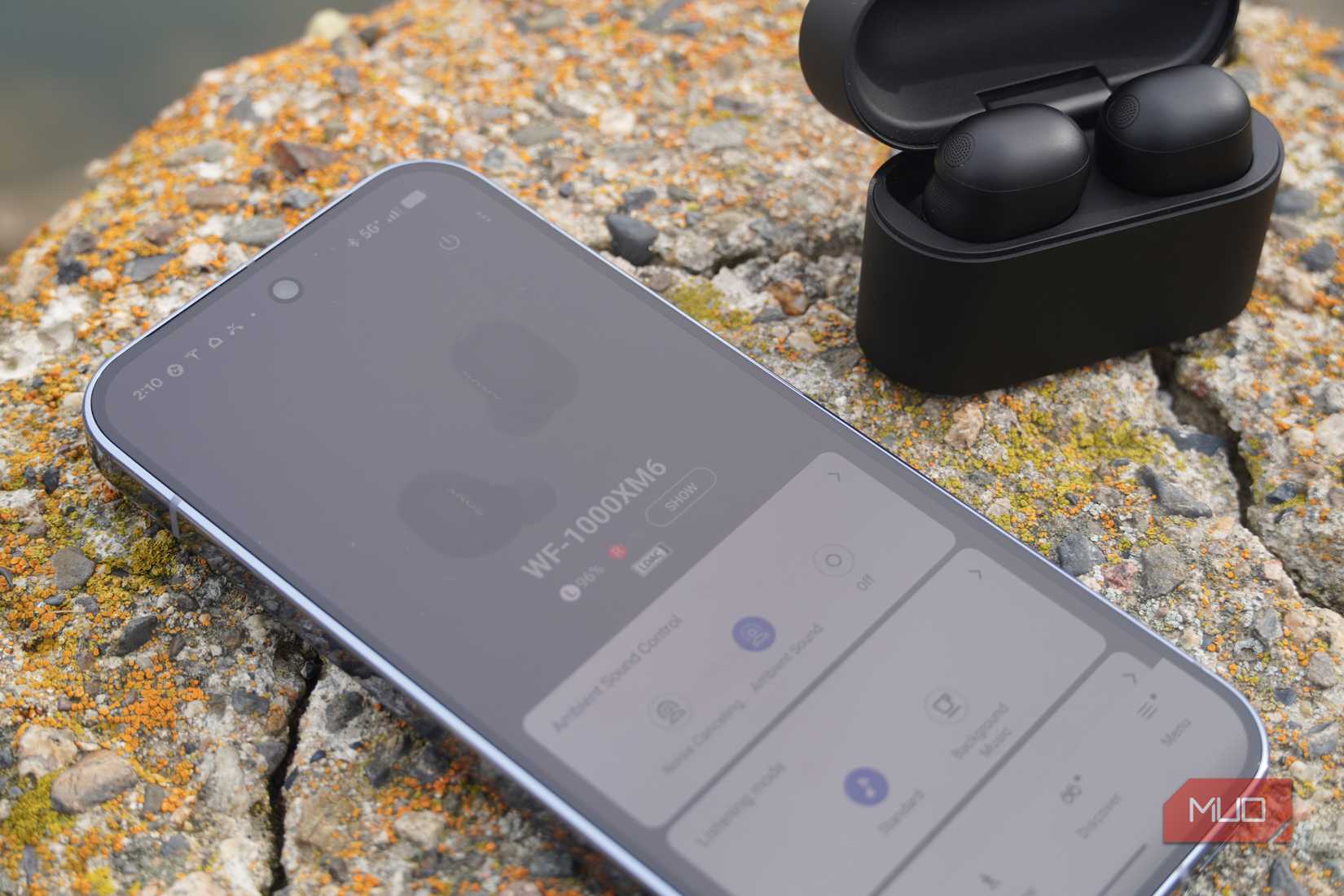 The Sony WF-1000XM6 app settings next to the earbuds.