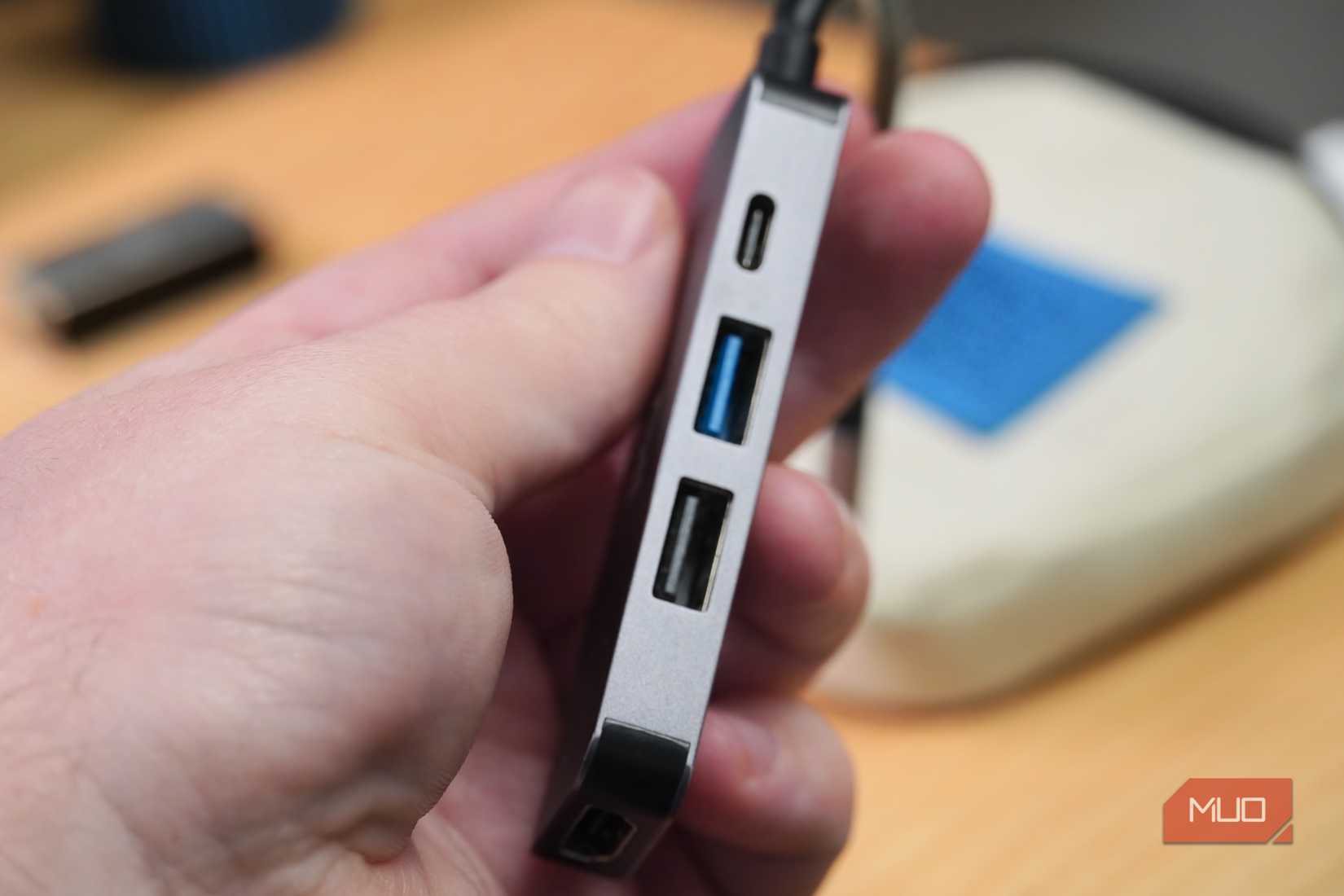 A small USB-C hub with a USB-C, two USB-A, and one HDMI ports.