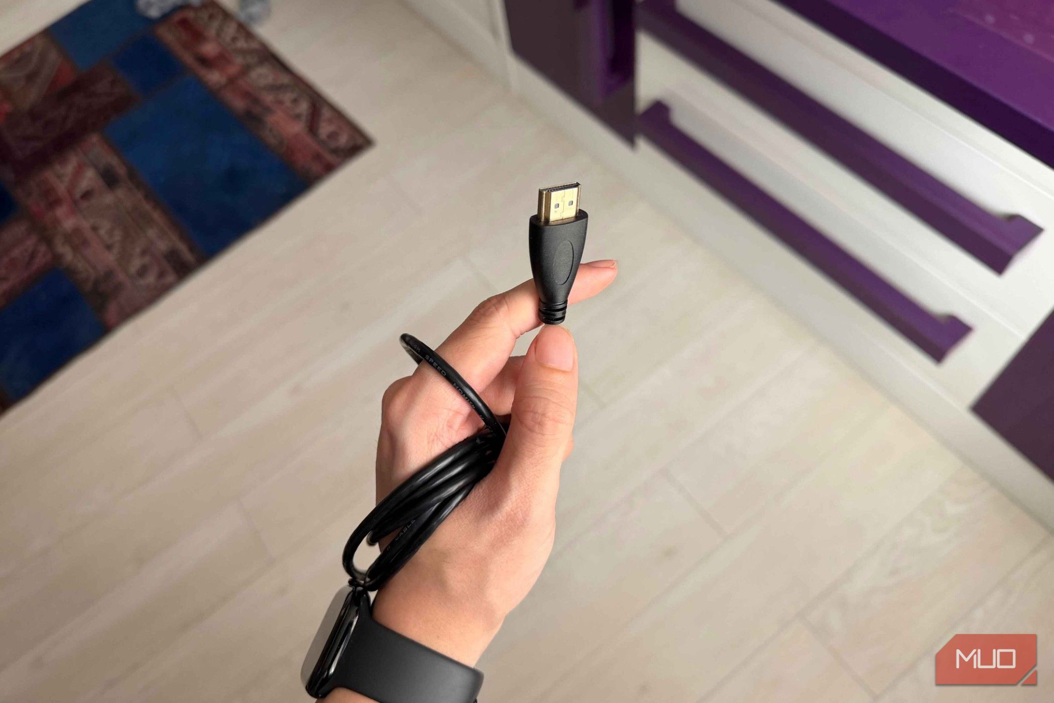 A hand holding an HDMI cable-1