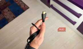A hand holding an HDMI cable-1