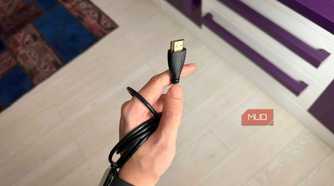 A hand holding an HDMI cable-1