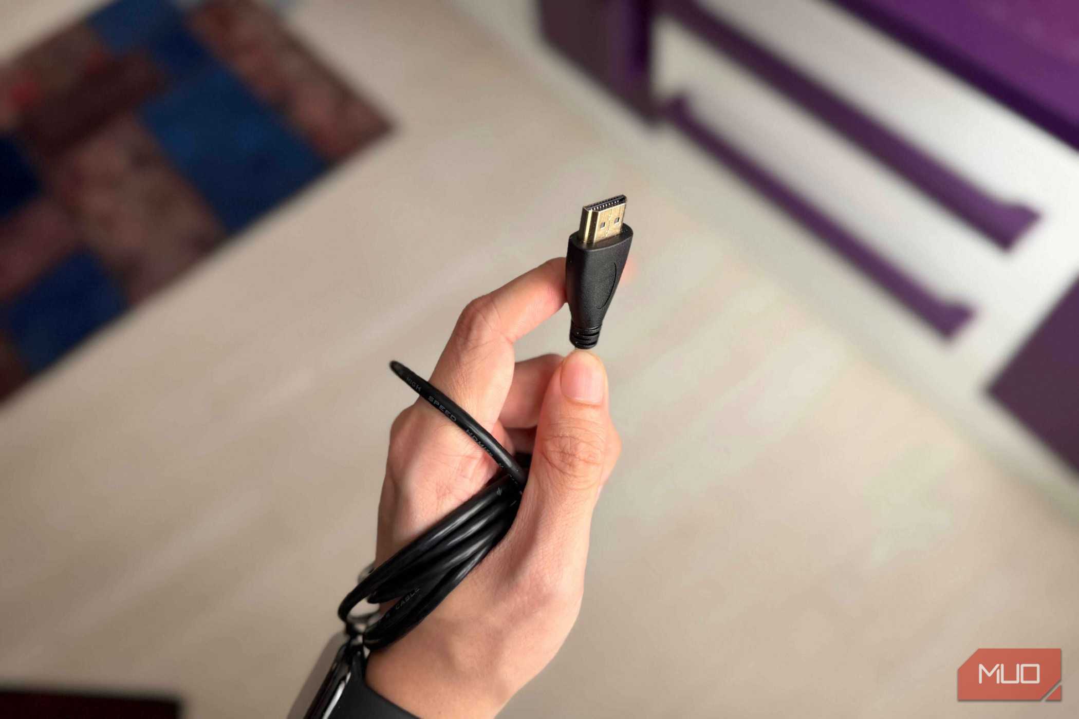 A hand holding an HDMI Type A cable