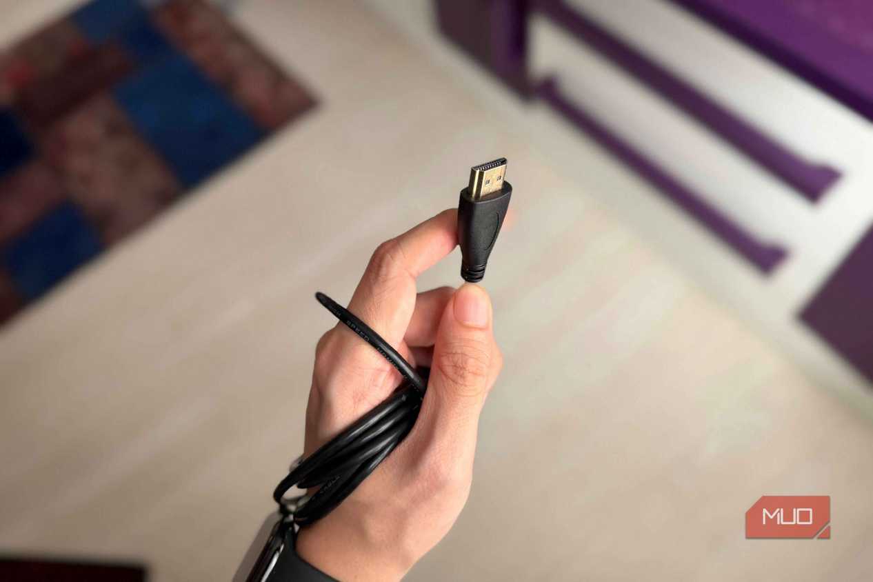 A hand holding an HDMI Type A cable