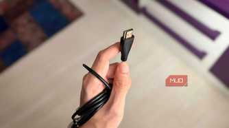 A hand holding an HDMI Type A cable