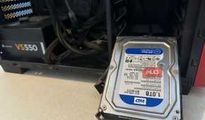 A WD Hard Drive next to a PC cabinet
