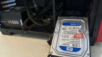 A WD Hard Drive next to a PC cabinet
