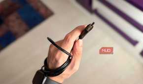 An HDMI cable and connector held in a hand