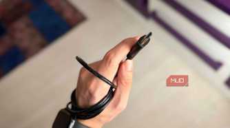 An HDMI cable and connector held in a hand