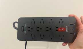 anker power strip plugged in with LEDs on