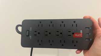 anker power strip plugged in with LEDs on