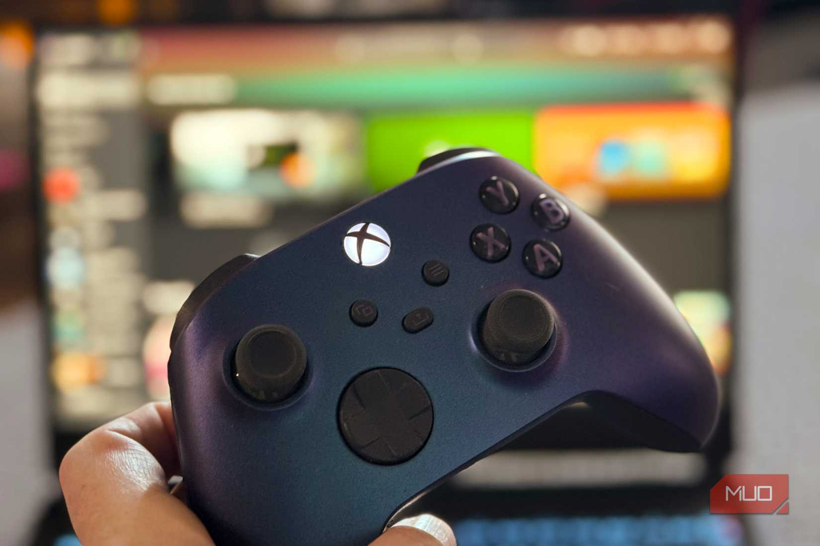 Xbox Wireless Controller in front of a PC running Xbox app