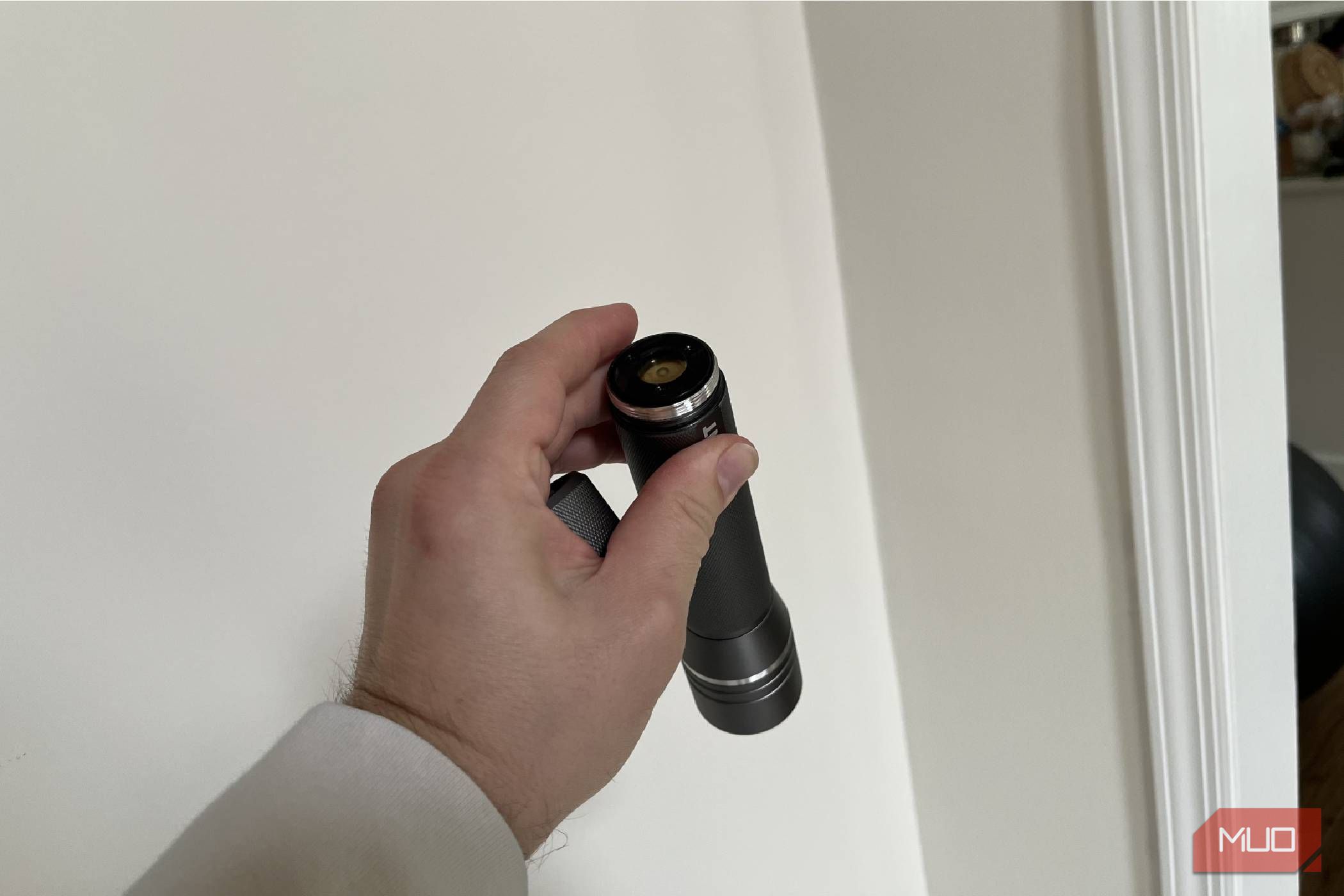 A flashlight with its cover off