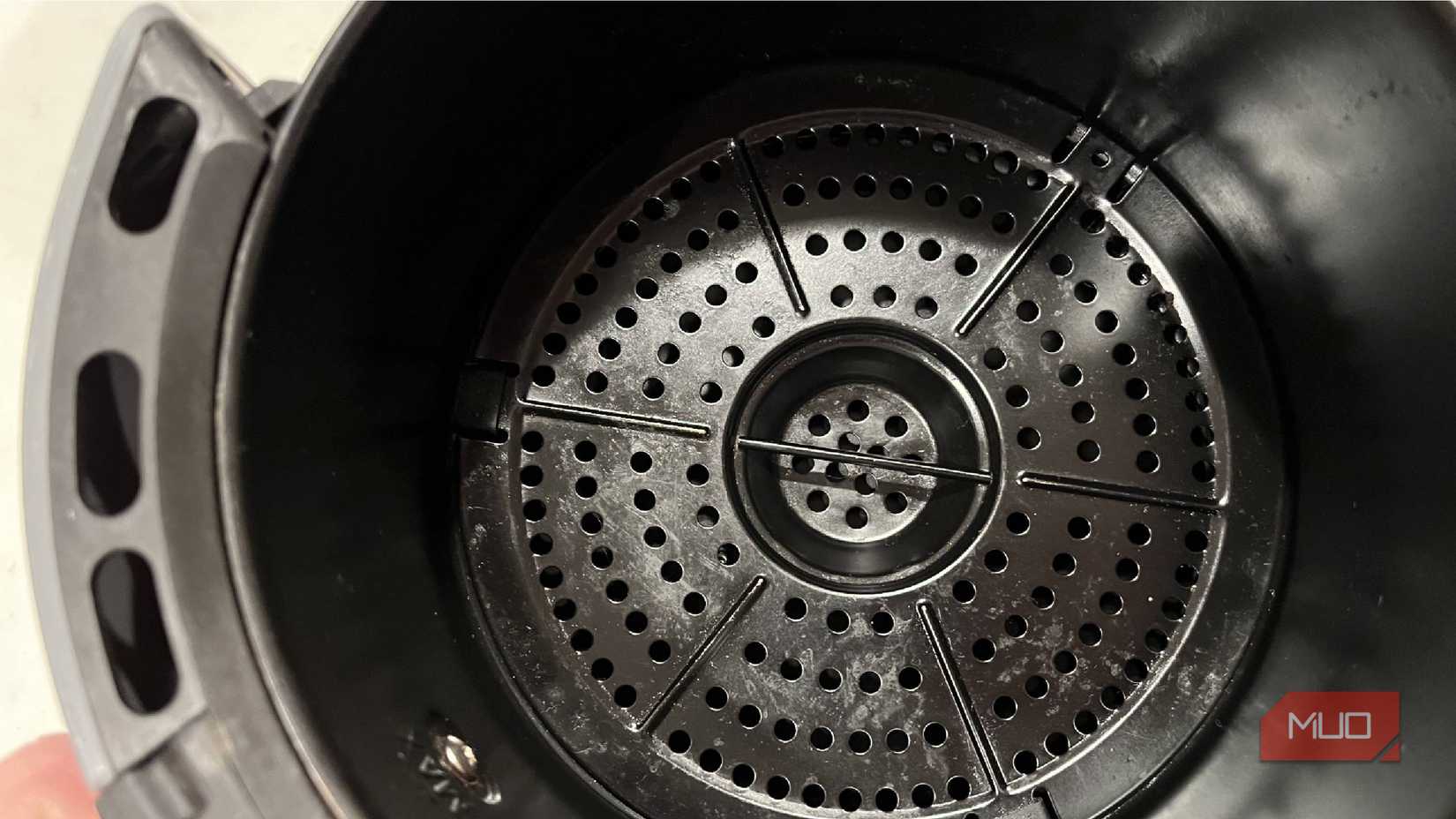 Inside a dirty air fryer tray