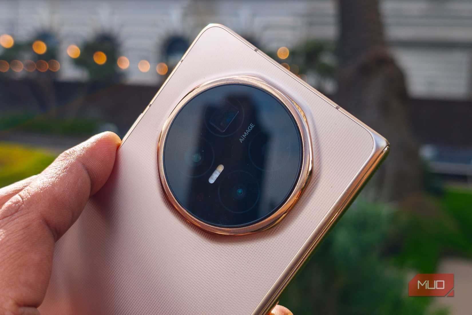 The cameras on the rear of the Honor Magic V6 Gold in the hand